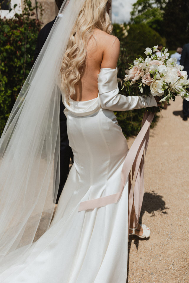 Bride in motion with wedding flowers at Elmore Court, relaxed editorial style