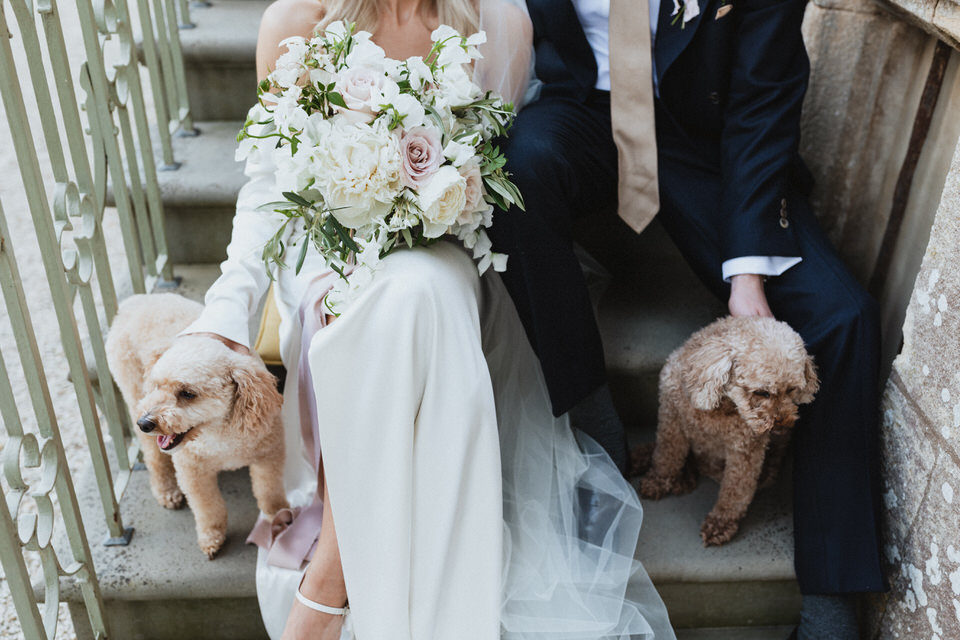 Elmore Court wedding photography. Relaxed wedding moment with couple and their two dogs at a Cotswolds venue